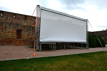 aluminum stage construction. large format white screen, tarpaulin, outdoor cinema in the park....