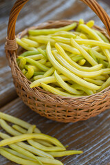yellow string beans in a wooden basket