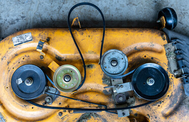 Top view of lawnmower deck belt replacement. Concept maintenance and repair