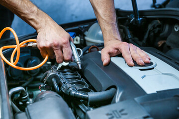 blowing out the engine with compressed air after washing. dry cleaning car engine