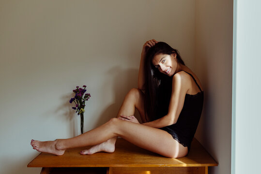 Charming Hispanic lady on table in room