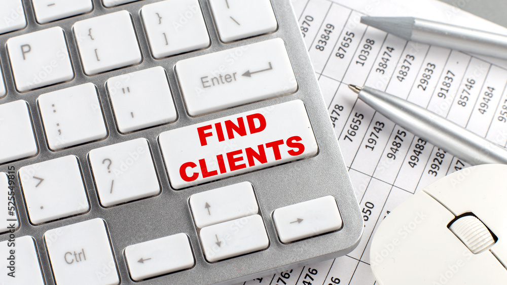 Poster find clients text on a keyboard wirh chart and pencil