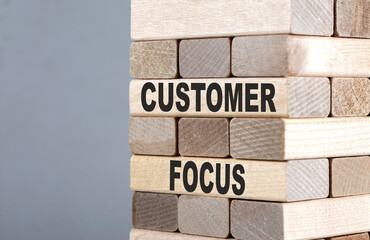 The text on the wooden blocks CUSTOMER FOCUS