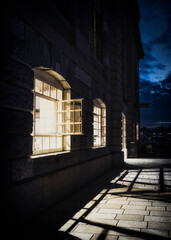 Fototapeta na wymiar Illuminated Open Window In A Bar At The Royal William Docks, Plymouth At Dusk