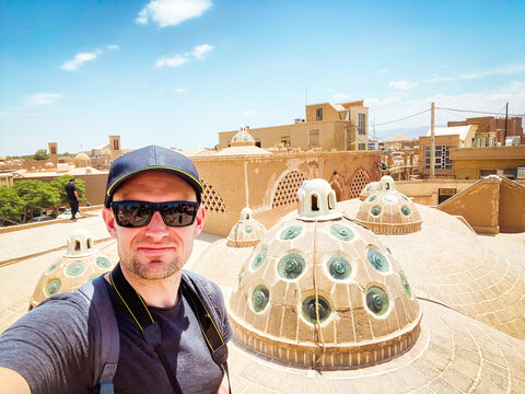 Young Caucasian Male Tourist Take Selfie On Famous Bathhouse Rooftop In Poplar Travel Destination - Sultan Amir Ahmad In KAshan City Landmark