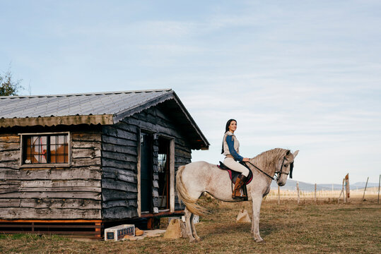 Woman ridding on white horse in nature