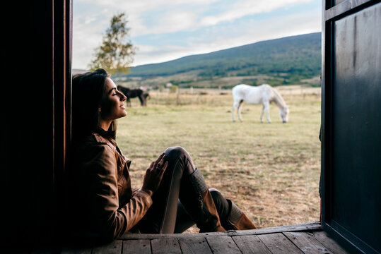 Sensual brunette sitting on house of ranch
