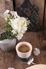 Small portion of coffee in a ceramic glass on a wooden table