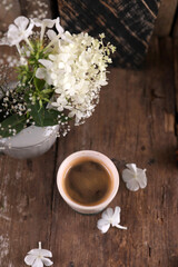 Small portion of coffee in a ceramic glass on a wooden table