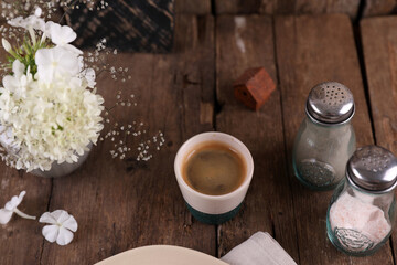 Obraz na płótnie Canvas Small portion of coffee in a ceramic glass on a wooden table