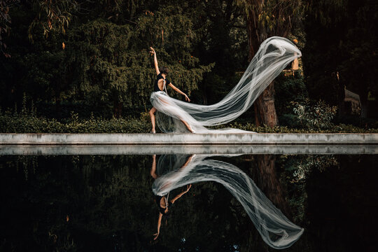 Fototapeta Young ballerina posing by the water