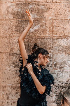 Young ballerina posing with a black dress