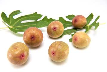 Organic fresh fig with leaves isolated on white background.