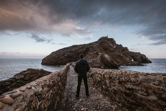 Traveler on the island of San Juan de Gaztelugatxe