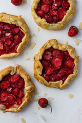 Mini-biscuits made of strawberries on a white background. Delicious mini-pies. Top view