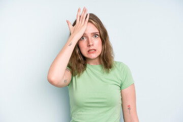 caucasian pretty woman raising palm to forehead thinking oops, after making a stupid mistake or...