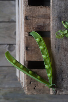 Closeup of pea pod on wood
