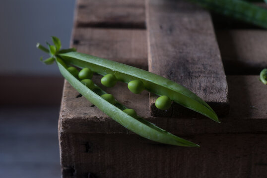 Closeup of pea pod on wood