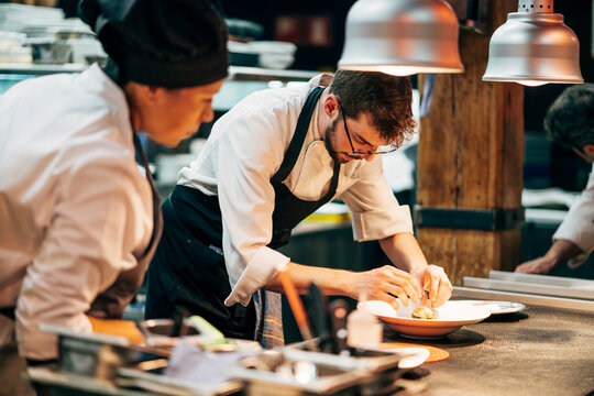 Coworking cooks serving food on counter