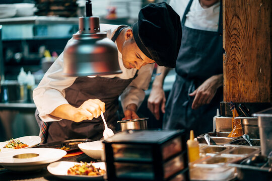Coworking cooks serving food on counter