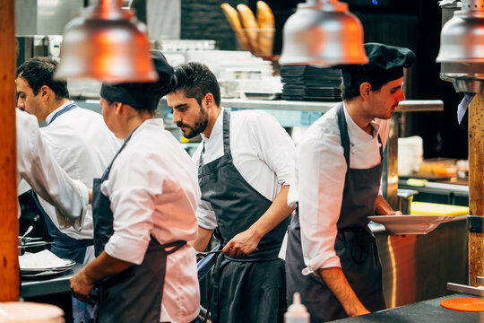 Coworking cooks serving food on counter