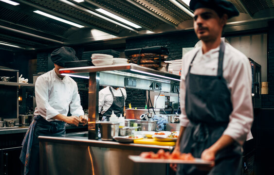 Coworking cooks serving food on counter