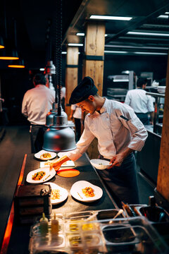 Man at counter serving dishes
