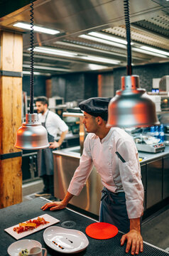 Coworking cooks serving food on counter