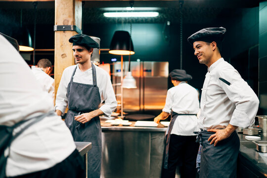 Coworking cooks serving food on counter