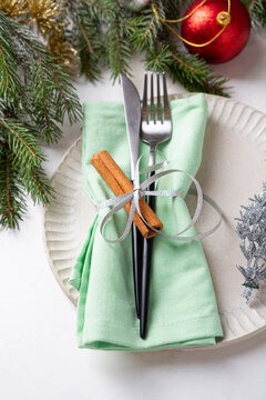 White plate and christmas decorations table setting close up