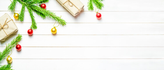 Fototapeta na wymiar Christmas banner. Christmas composition. Fir branches, christmas gifts, christmas decorations on white wooden background. Copy space