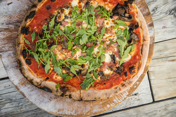 freshly made oven italian pizza served on rustic wooden table ready for lunch