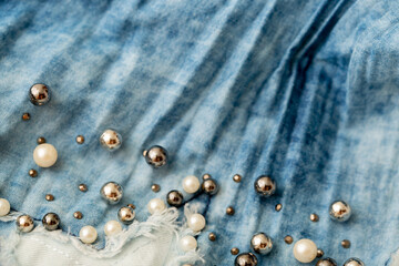 Jeans background clothing. Denim fabric closeup. Textures of clothing made of fabric with fashionable embroidery of pearl beads. Copy space for text. Fashionable style.
