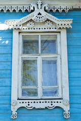 Window with carved platbands of an old wooden house