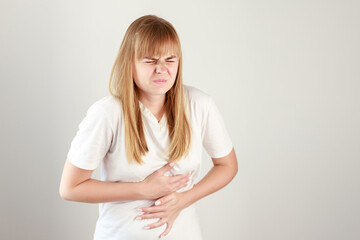 a woman has a severe stomach ache on a white background