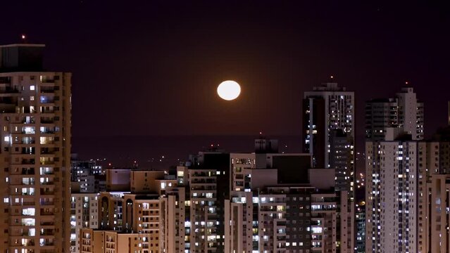 SLIDE Lunar Symphony: Captivating Moonrise Time Lapse Over City Skyline 4k, HDR DOLLY