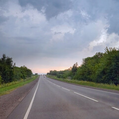 Highway under a dark cloudy sky