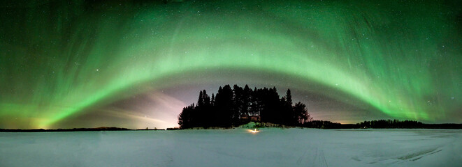 Panoramic view of Northern lights over peninsula in Norrbotten, Sweden