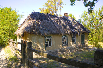 Fototapeta na wymiar Old Ukrainian house near lake Buchak in forest in Cherkasy region, Ukraine 