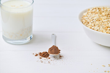 plate of oatmeal and cocoa carob and a glass of milk. healthy food. diet. - obrazy, fototapety, plakaty