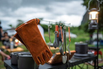 Fototapeta na wymiar Leather gloves and kitchen utensils for camping