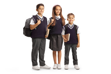 Two boys and one girl in school uniforms carrying backpacks