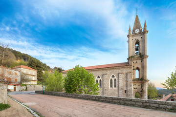Fototapeta na wymiar Majestic evening cityscape with Parish Church of the Assumption in Zonza village
