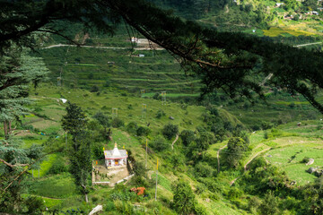 Fototapeta na wymiar A Small hindu temple on the hills of Himalayas . Uttarakhand India.