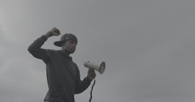 MS Young man protesting at rally with megaphone