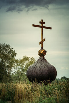 Old russsian chirch tip with golden cross separate bring down on ground and grass