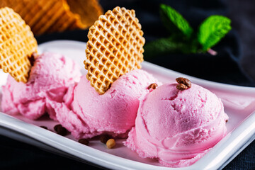 Delicious dessert on black background. Strawberry ice cream.