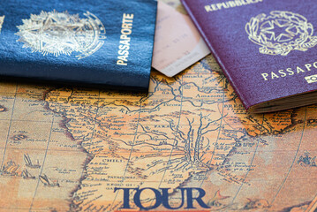 Brazilian and Italian passports on an ancient map of South America ready for the tour. Holidays...