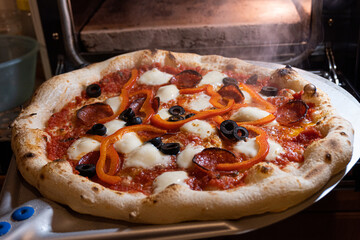 pizza coming from the oven