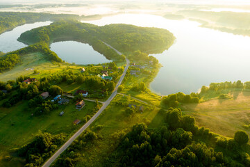 Lake on sunset, drone view. Rural landscape with lakes. Sunset over the forest lake. Drink water safe. Global drought crisis. Pond in countryside with fields and forest. Forest Lake at sunset. Nature.